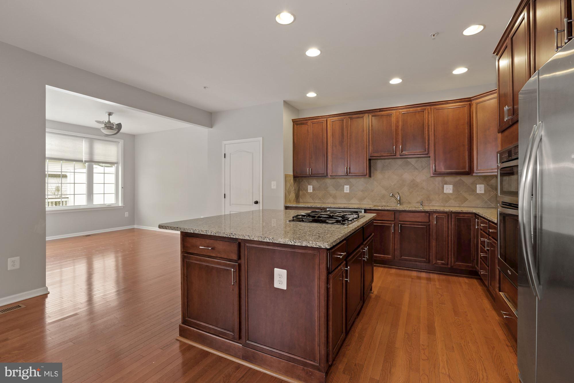 11007 Buggy Path Upper Marlboro, MD 20772 - Photo 4 of 18 a kitchen with stainless steel appliances granite countertop a stove a sink and a refrigerator