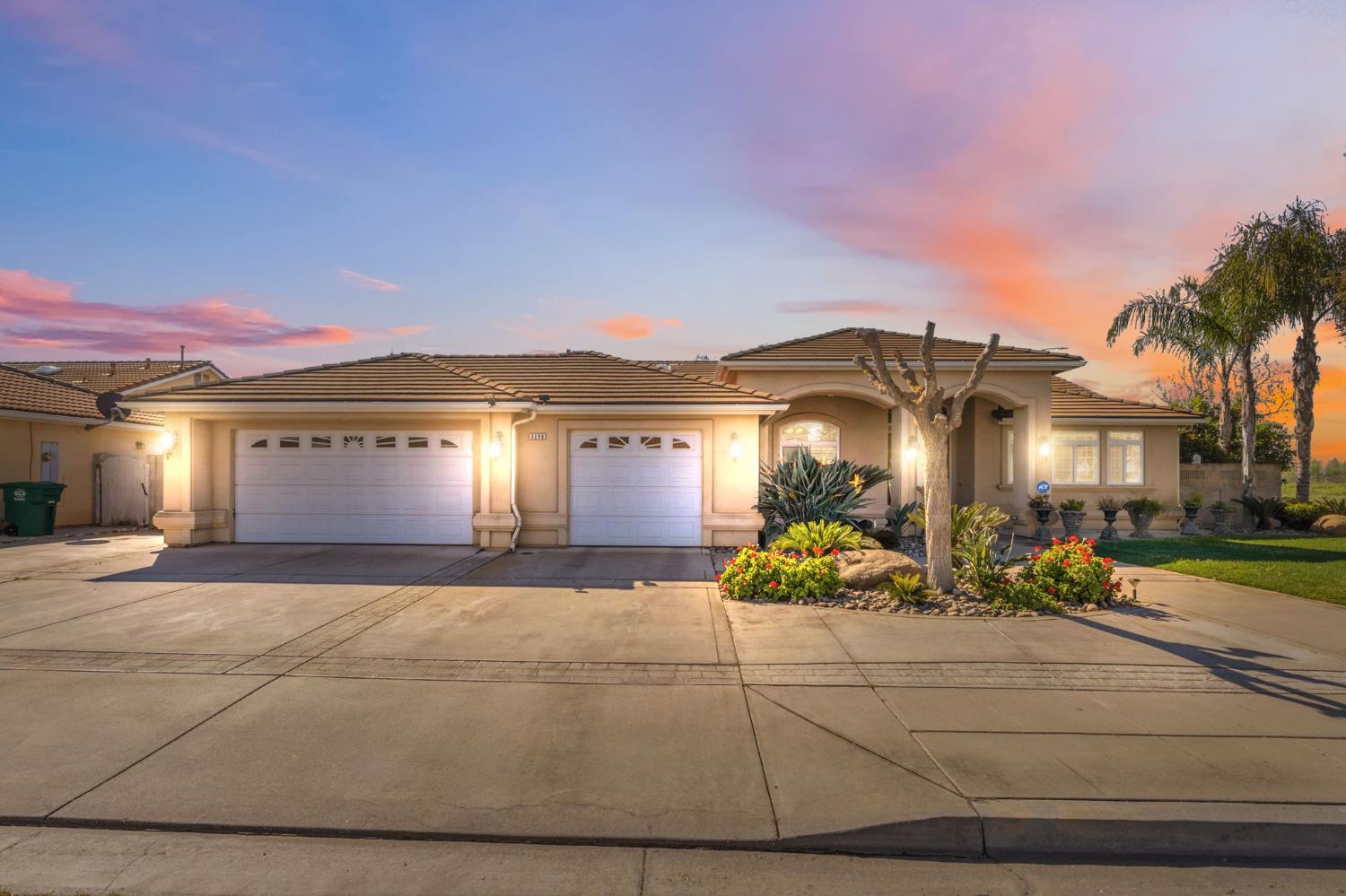 3296 Hollow Avenue Madera, CA 93637 - Photo 1 of 45 a view of a white house with a fountain in front of it