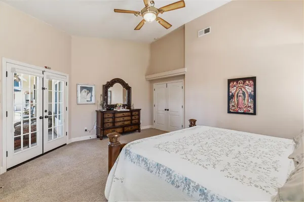 a bedroom with a bed and a dresser with mirror
