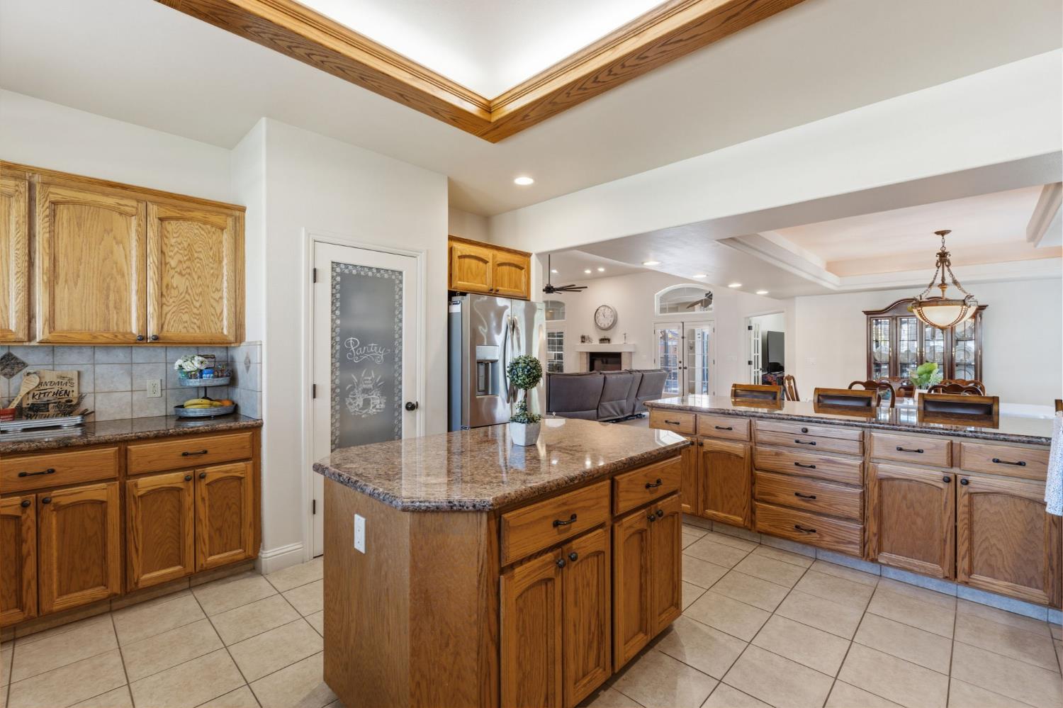 3296 Hollow Avenue Madera, CA 93637 - Photo 15 of 45 a kitchen with a sink stove and cabinets
