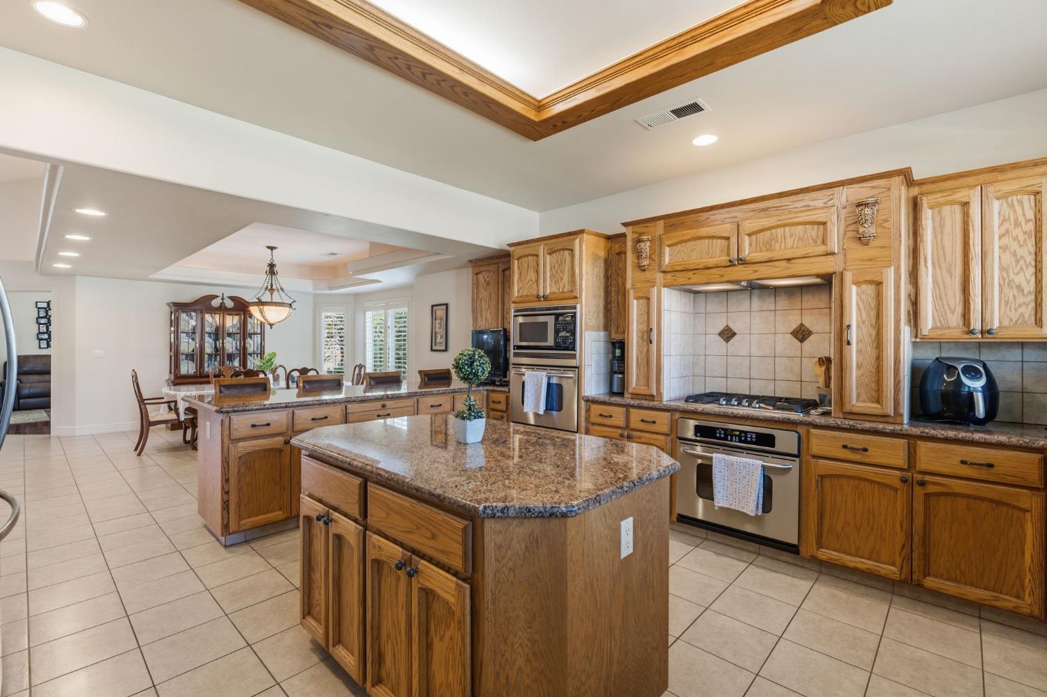 3296 Hollow Avenue Madera, CA 93637 - Photo 16 of 45 a kitchen with stainless steel appliances granite countertop a stove and a sink