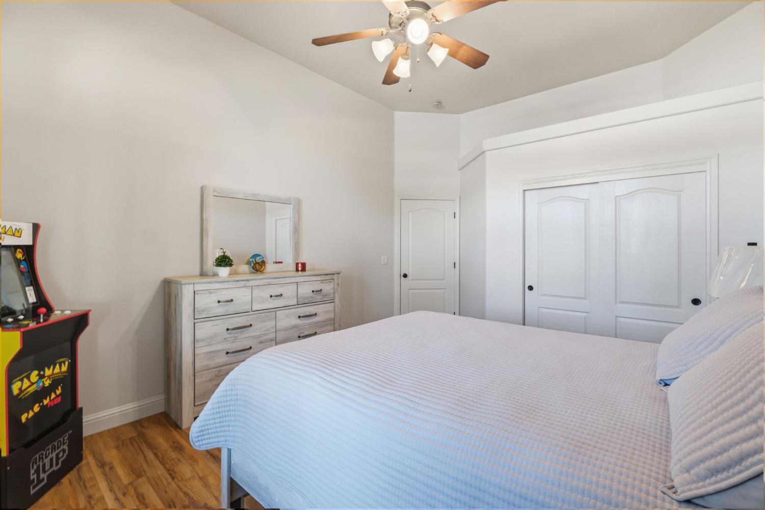 3296 Hollow Avenue Madera, CA 93637 - Photo 18 of 45 a bedroom with a bed and a chandelier