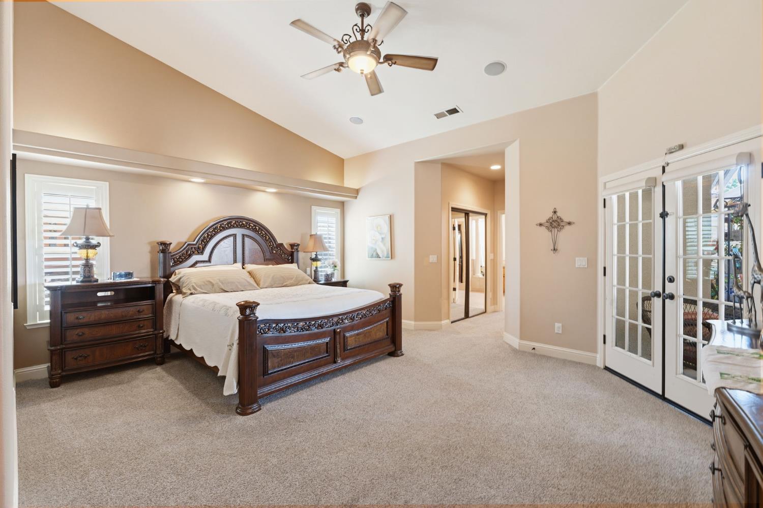 3296 Hollow Avenue Madera, CA 93637 - Photo 23 of 45 a spacious bedroom with a bed and a chandelier