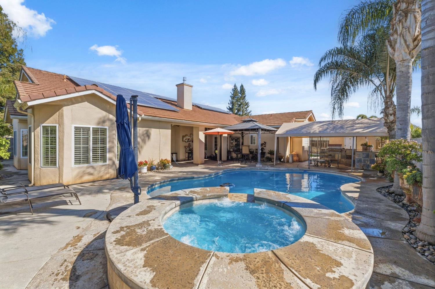 3296 Hollow Avenue Madera, CA 93637 - Photo 35 of 45 a view of a house with swimming pool and sitting area
