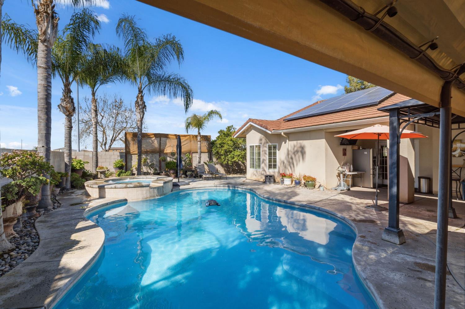 3296 Hollow Avenue Madera, CA 93637 - Photo 36 of 45 a view of a patio with swimming pool table and chairs