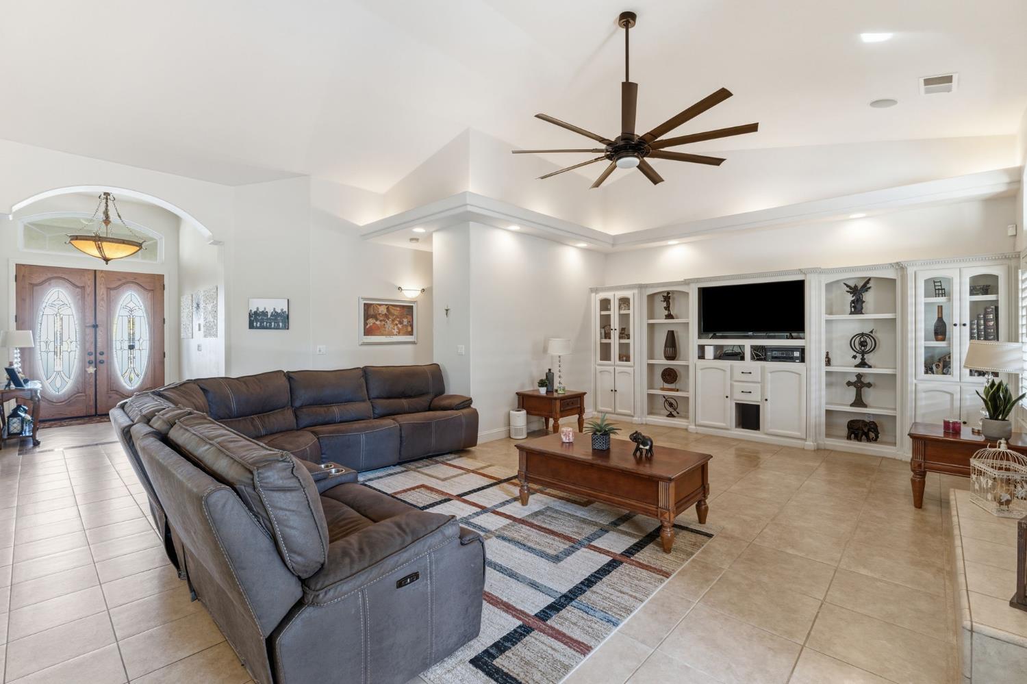3296 Hollow Avenue Madera, CA 93637 - Photo 8 of 45 a living room with furniture and a flat screen tv