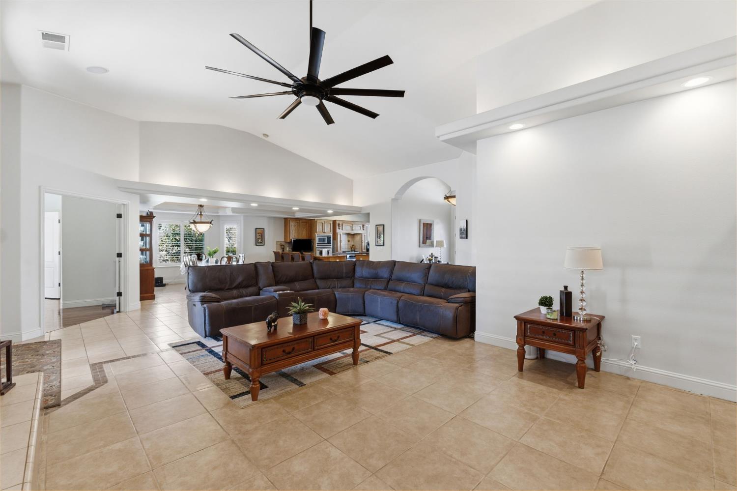 3296 Hollow Avenue Madera, CA 93637 - Photo 9 of 45 a living room with couches and a dining table with wooden floor