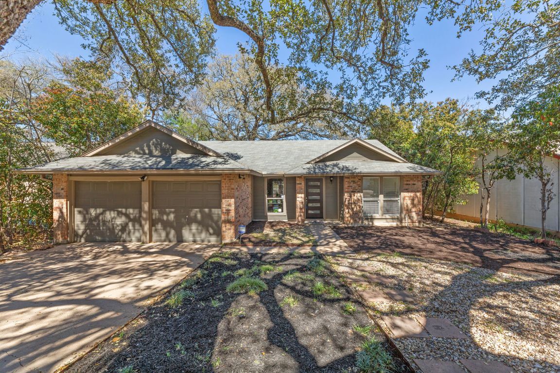 5004 Powder River Road Austin, TX 78759 - Photo 1 of 1 a front view of a house with a yard