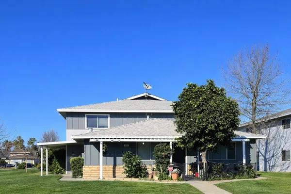 a front view of a house with a garden
