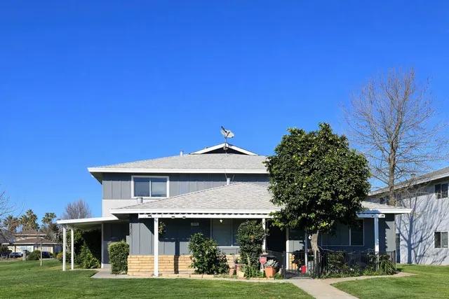 a front view of a house with a garden