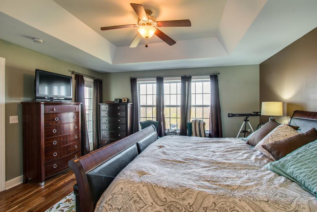 7100 Dale Ridge Road, Unit E3 Lancaster, TN 38569 - Photo 14 of 30 a bedroom with a large bed a flat tv screen and dresser