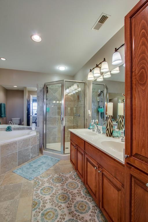 7100 Dale Ridge Road, Unit E3 Lancaster, TN 38569 - Photo 16 of 30 a large bathroom with a large mirror vanity and shower