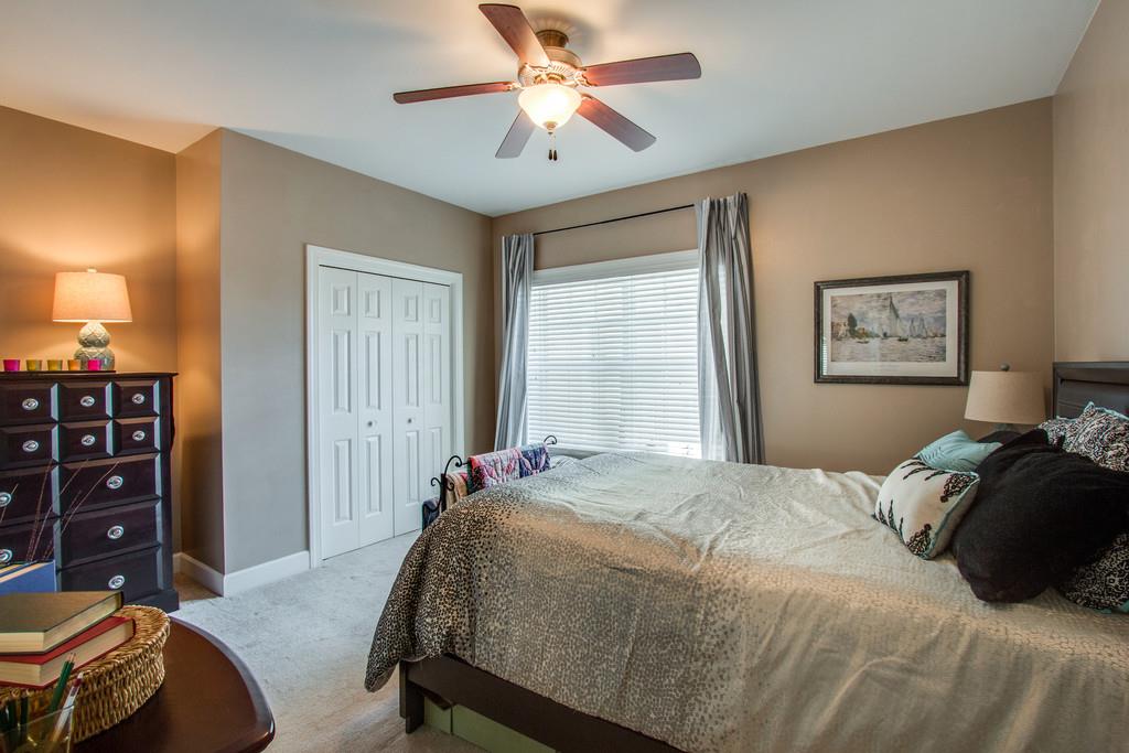 7100 Dale Ridge Road, Unit E3 Lancaster, TN 38569 - Photo 20 of 30 a bedroom with a bed a dresser and a chandelier