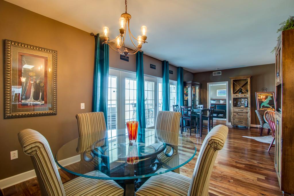 7100 Dale Ridge Road, Unit E3 Lancaster, TN 38569 - Photo 5 of 30 a view of a dining room with furniture a chandelier and wooden floor