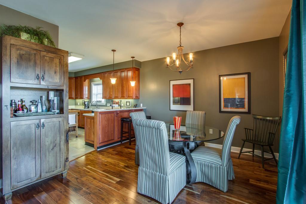 7100 Dale Ridge Road, Unit E3 Lancaster, TN 38569 - Photo 6 of 30 a view of a dining room with furniture a chandelier and wooden floor