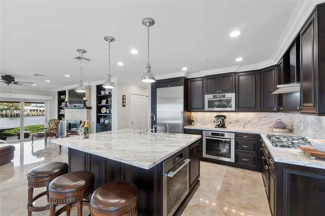 a room with furniture and a floor to ceiling window next to a yard