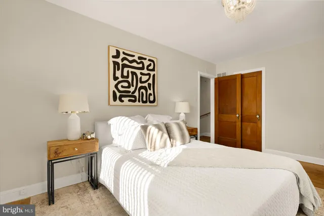 a bedroom with a bed and a night stand