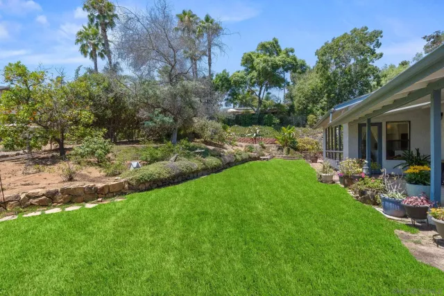 a living room with furniture a fireplace a lamp and a large window