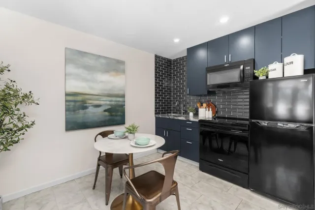 a spacious bedroom with a bed a table and chair