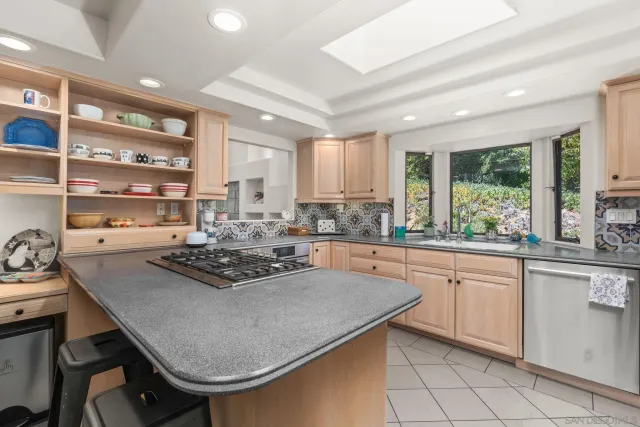 a kitchen with stainless steel appliances granite countertop a stove and cabinets