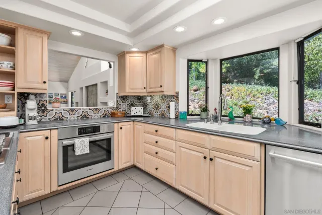 a kitchen with stainless steel appliances granite countertop a stove and cabinets
