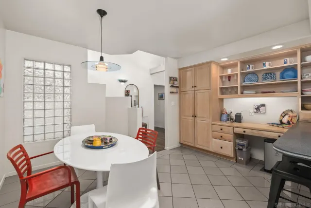 a bedroom with a bed couches and a flat tv screen