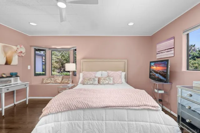 a bathroom with a granite countertop toilet sink and mirror