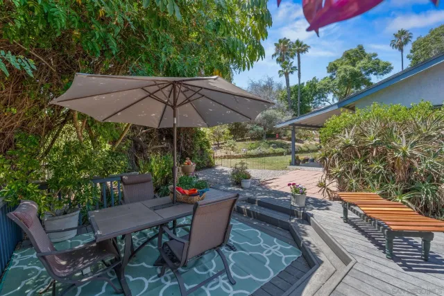 an outdoor space with furniture and umbrella
