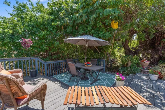 a view of balcony with wooden floor and outdoor seating