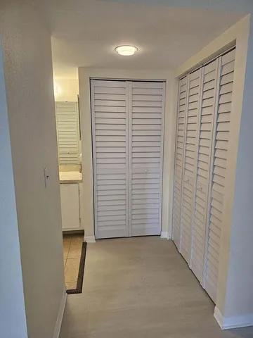 an empty room with windows and closet