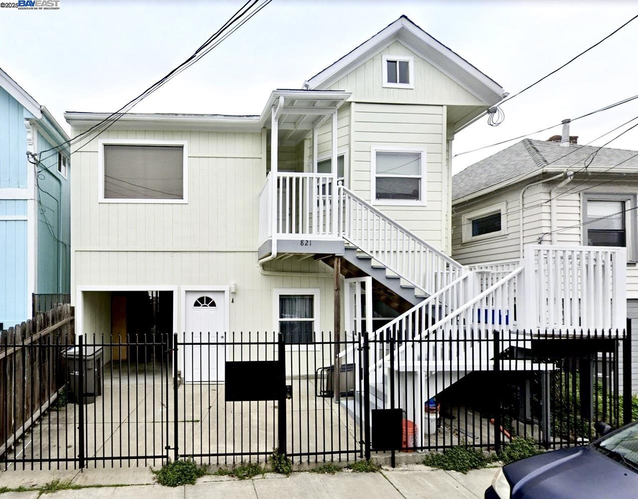 a front view of a house with a iron gate
