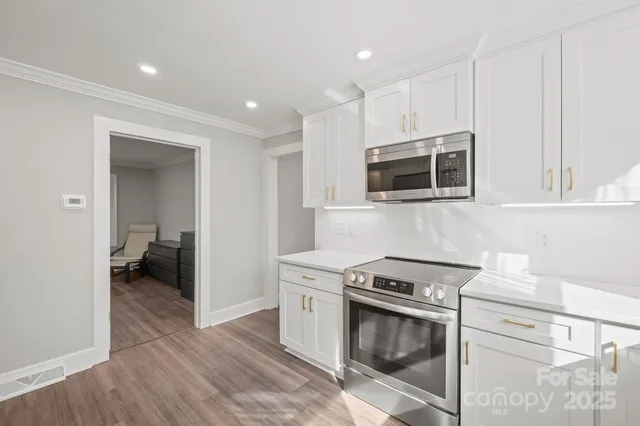 a kitchen with a stove and a microwave