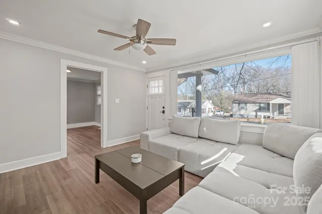 a living room with furniture and a large window