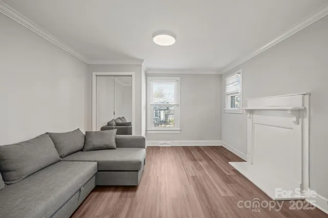 a living room with furniture and a hard wood floor