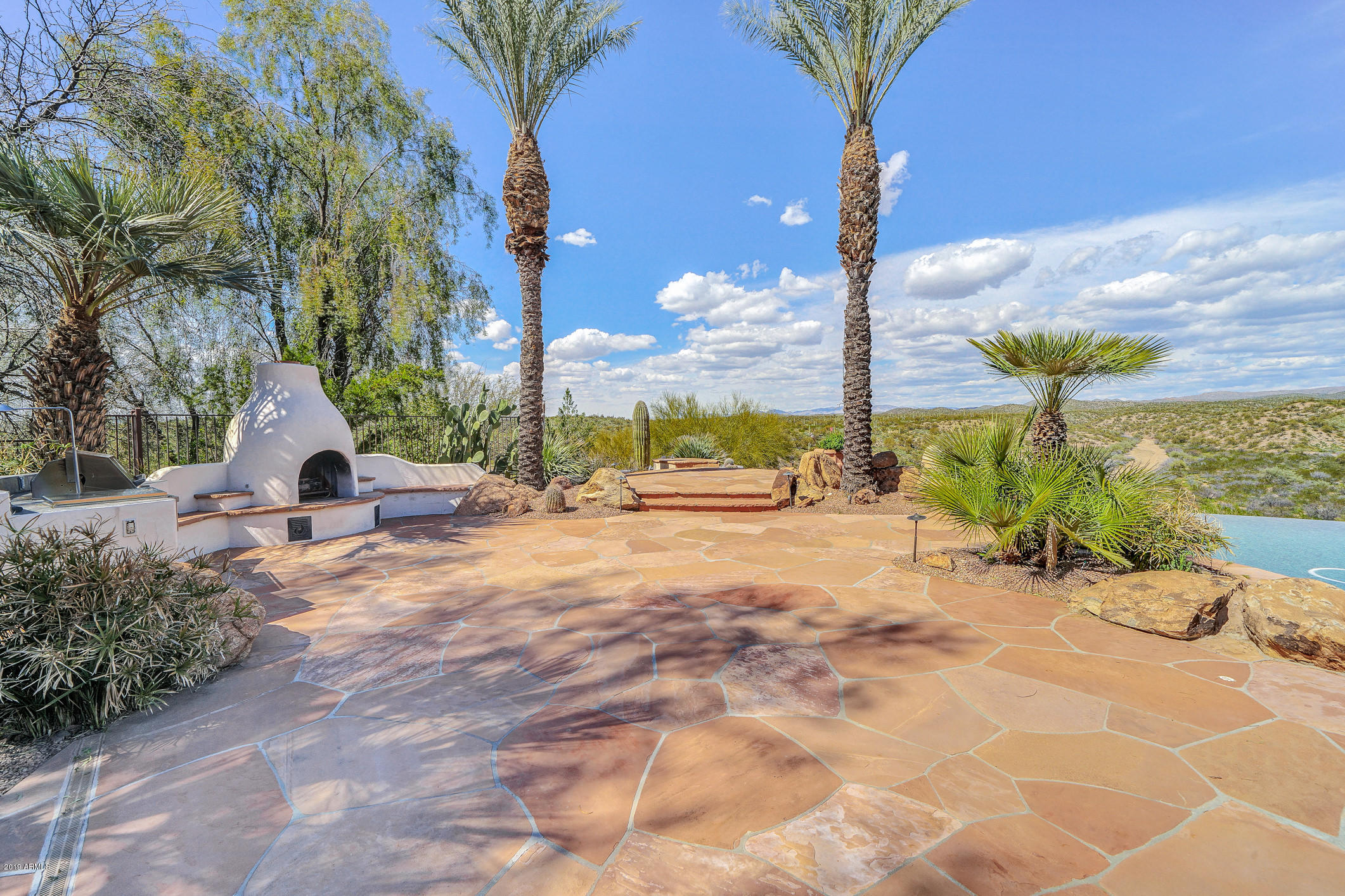 28331 West Rocking Horse Lane Morristown, AZ 85342 - Photo 62 of 85 239-RearPatio_KivaFireplace