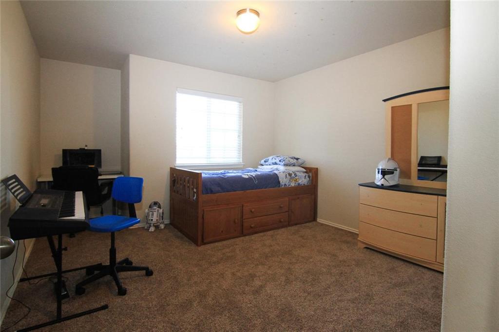 2705 Overton Street Round Rock, TX 78665 - Photo 12 of 19 a bed room with furniture and a window