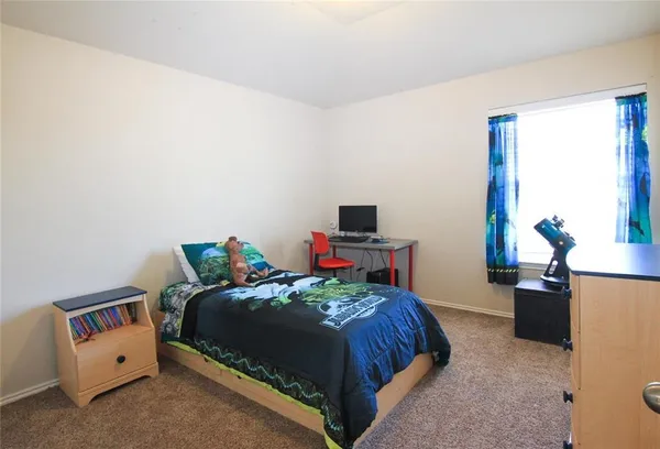 a bedroom with a bed and a desk