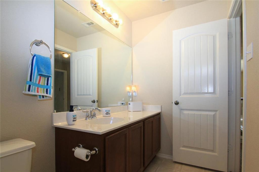 2705 Overton Street Round Rock, TX 78665 - Photo 15 of 19 a bathroom with a sink and a mirror