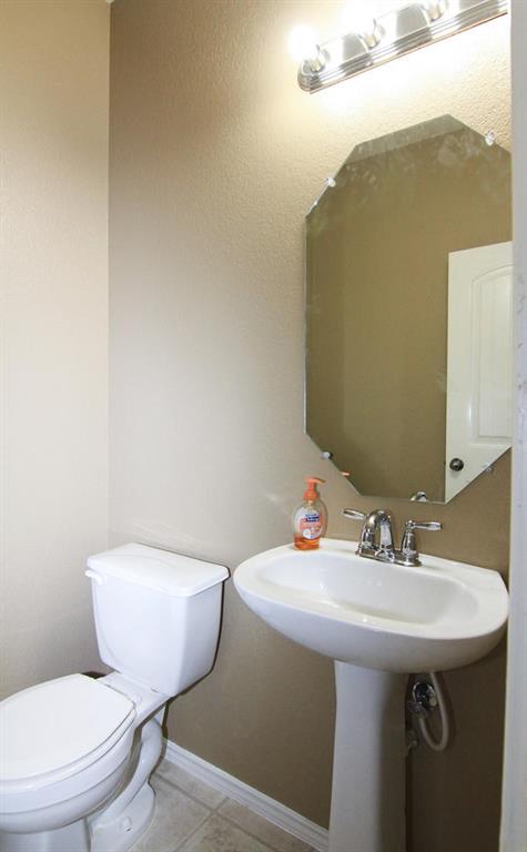 2705 Overton Street Round Rock, TX 78665 - Photo 16 of 19 a bathroom with a toilet sink and mirror