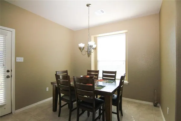 a view of a dining room with furniture and window