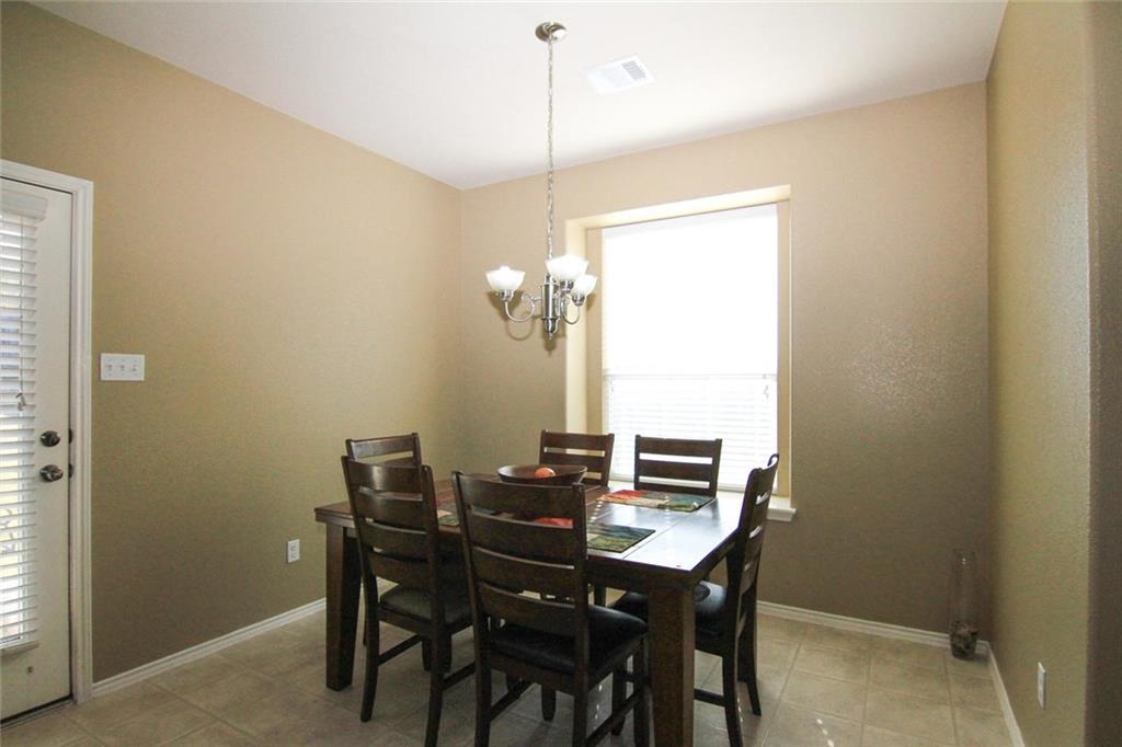 2705 Overton Street Round Rock, TX 78665 - Photo 7 of 19 a view of a dining room with furniture and window