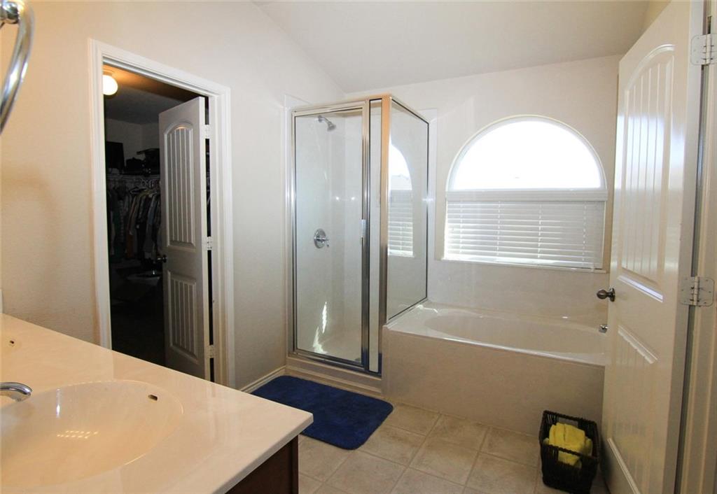 2705 Overton Street Round Rock, TX 78665 - Photo 10 of 19 a bathroom with a tub a sink and a shower