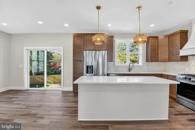 a kitchen with cabinets and wooden floor