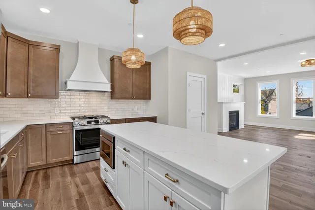 a kitchen with a stove cabinets and wooden floor