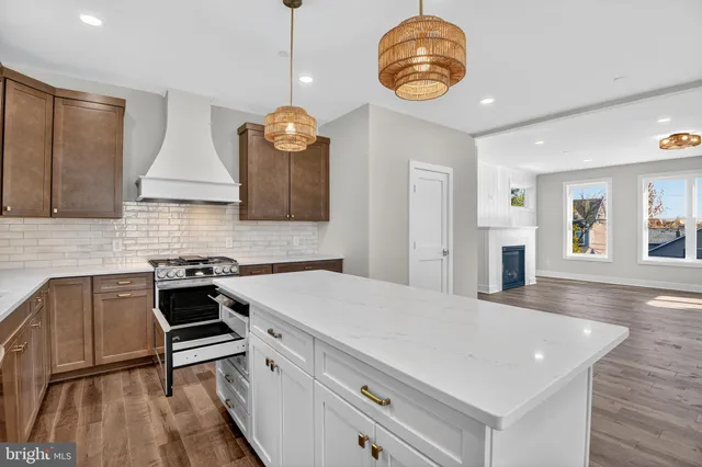 a kitchen with stainless steel appliances a table chairs and chandelier