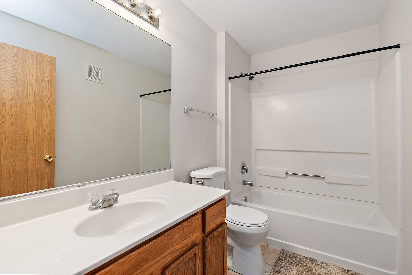 1809 Silverstone Drive, Unit 1809 Carpentersville, IL 60110 - Photo 12 of 17 a bathroom with a sink toilet and shower