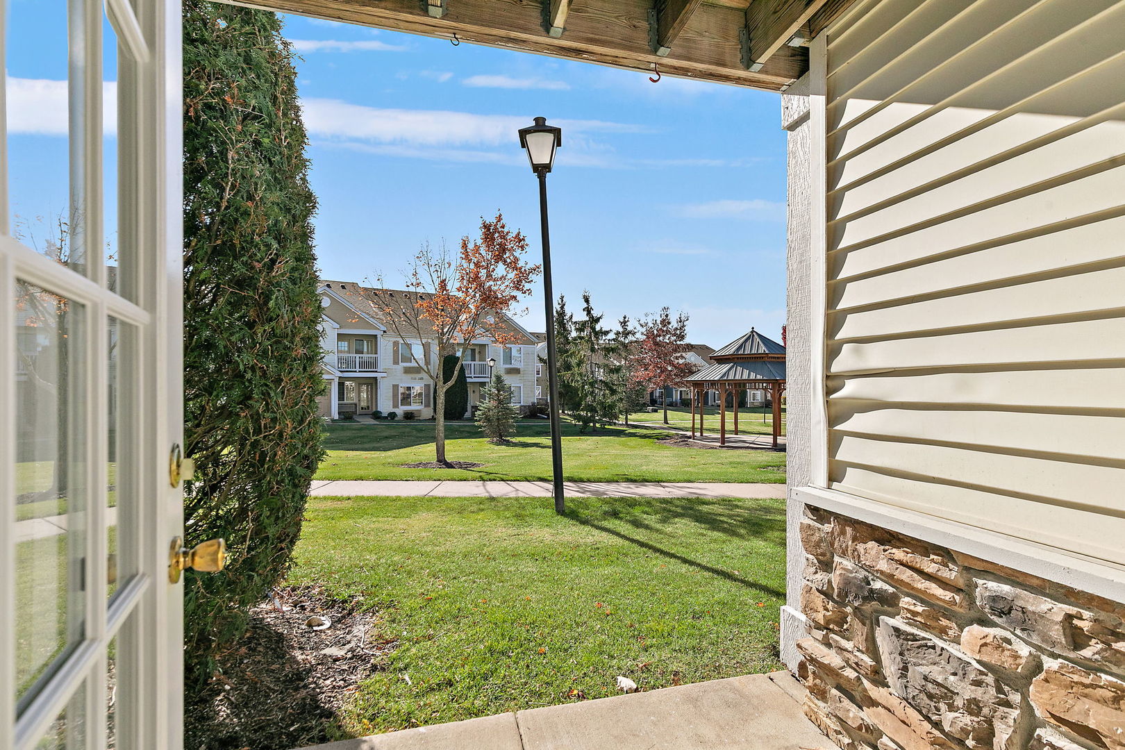 1809 Silverstone Drive, Unit 1809 Carpentersville, IL 60110 - Photo 16 of 17 a view of a garden with a bench in the patio