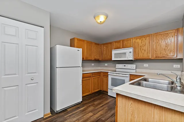 a kitchen with a refrigerator sink and cabinets