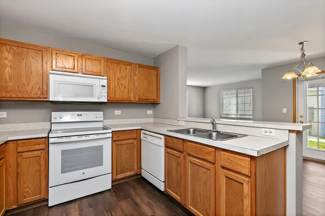 a kitchen with stainless steel appliances granite countertop a sink stove and cabinets