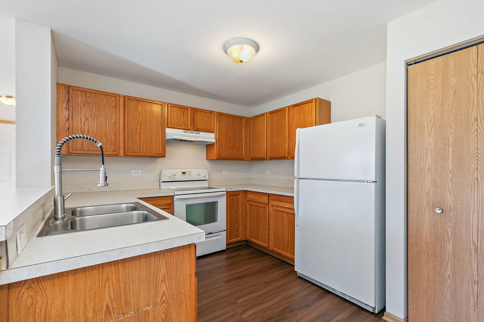 1809 Silverstone Drive, Unit 1809 Carpentersville, IL 60110 - Photo 7 of 17 a kitchen with a refrigerator sink and wooden cabinets
